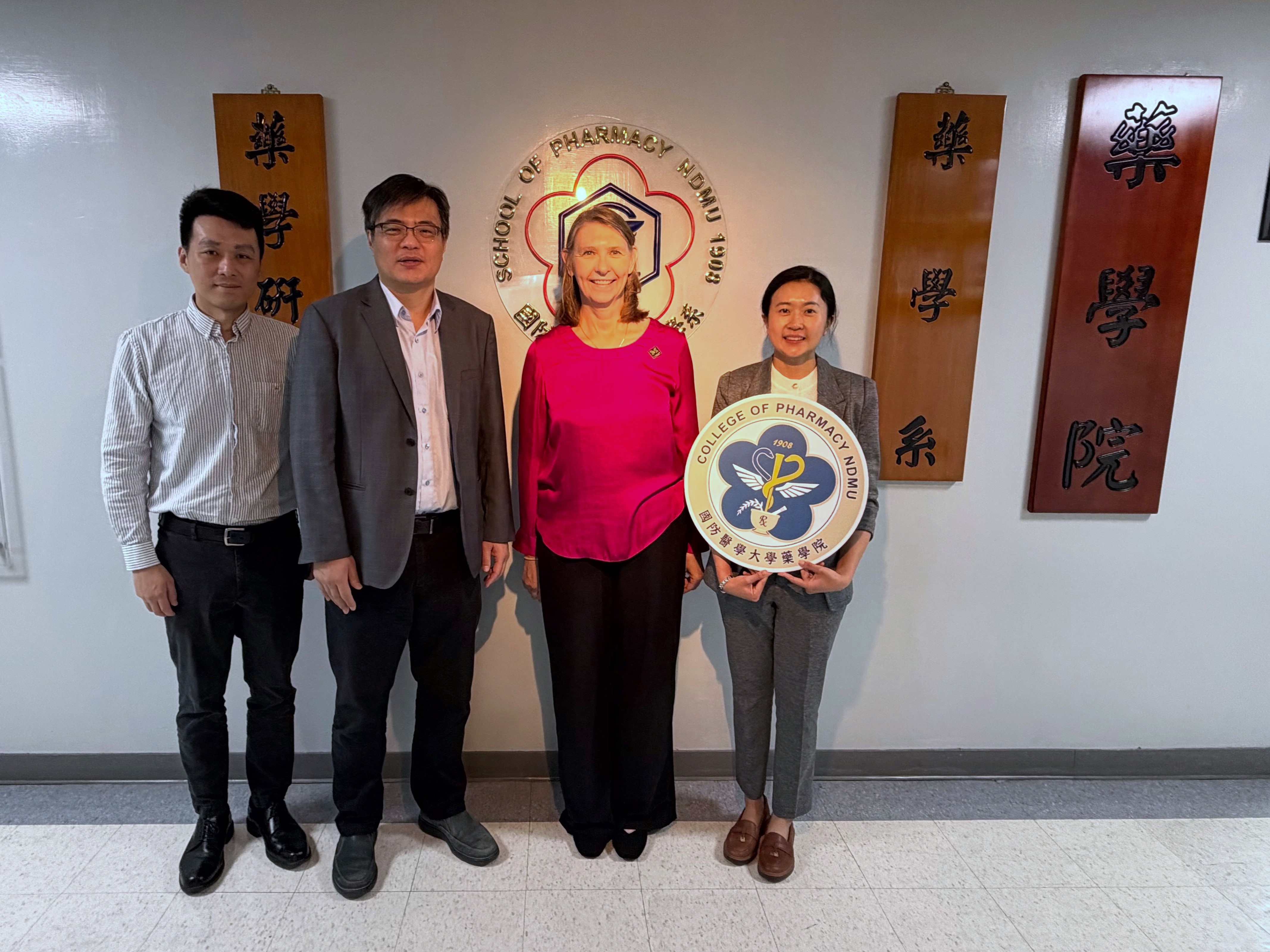 Group Photo at the School of Pharmacy Logo
